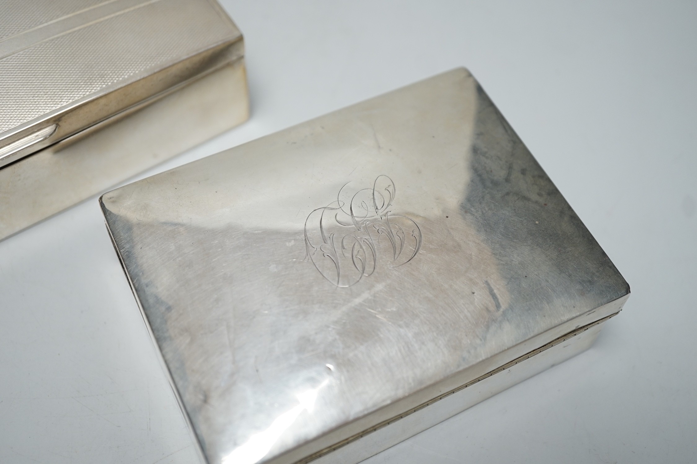 A modern part engine tuned silver mounted cigarette box, 17cm and one other smaller silver mounted cigarette box.